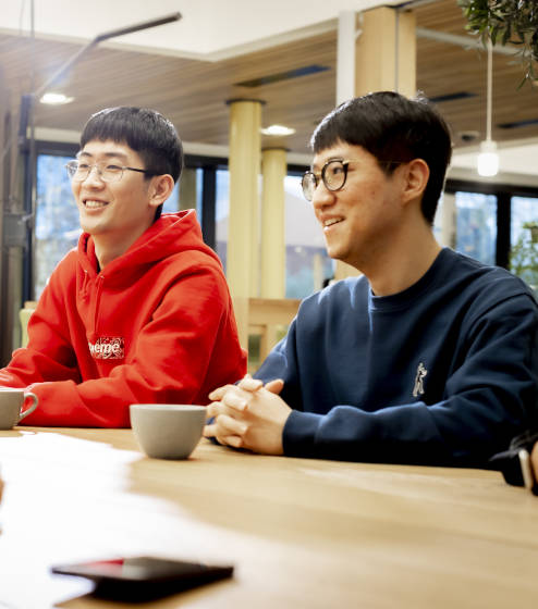 Group of people sitting and talking around the table
