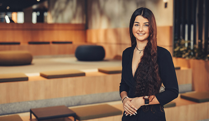 Female student standing smiling at the camera