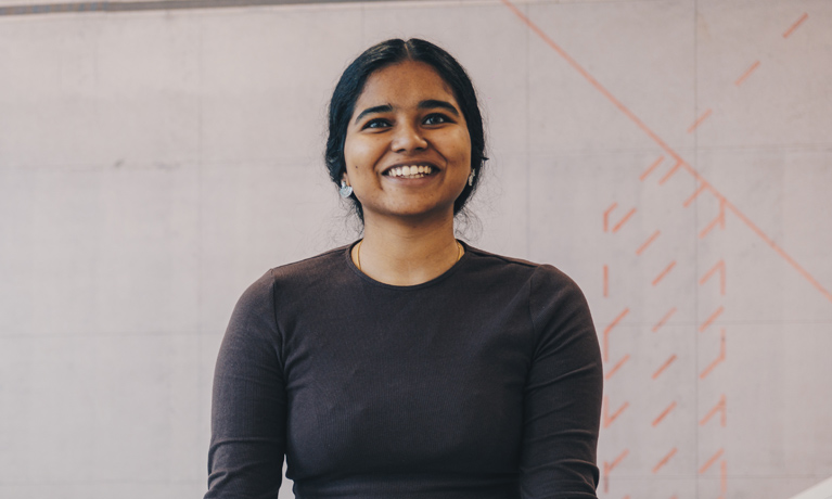 A student at Coventry University Wrocław in front of a whiteboard in a classroom