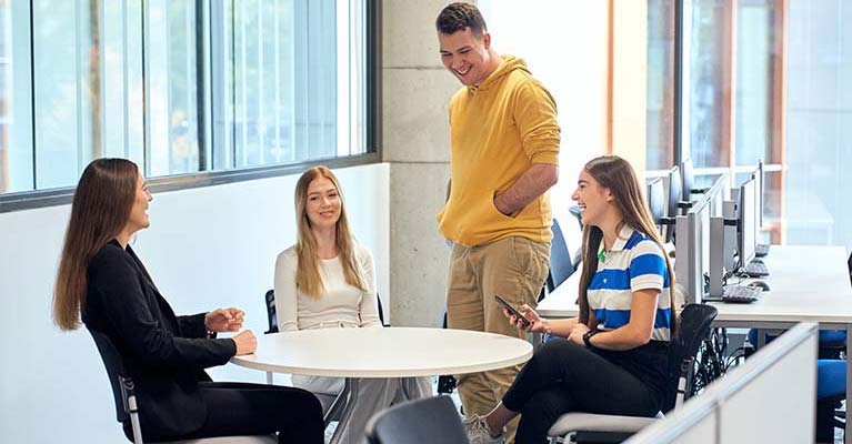 three female students and 1 male student chatting 