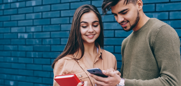 Man and woman looking at a phone screen