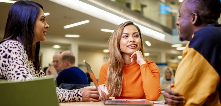 Students conversating with each other in a study space