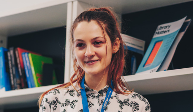 Female student smiling in the library.