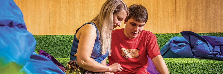two students looking at an ipad