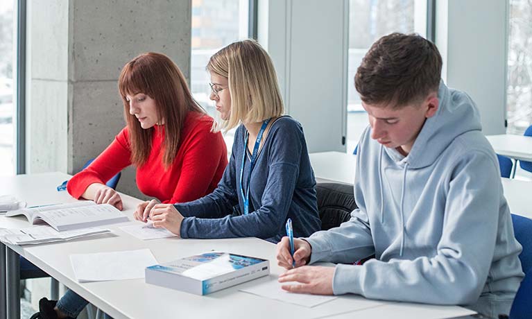Wroclaw students study at desk.