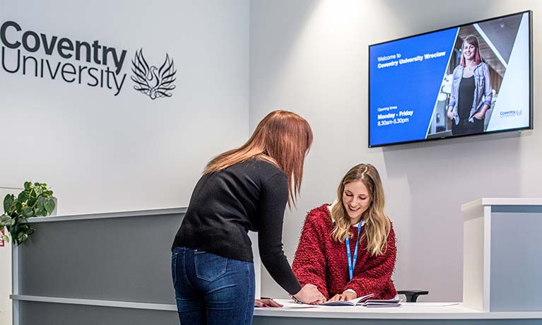 Student at a reception desk.